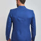 Back view of man wearing a blue tailored blazer and beige trousers
