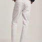Dalydress men's white jeans, back view, styled with brown shoes and navy shirt