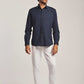 Dalydress men's fashion model in navy shirt, white pants, and brown shoes, studio background