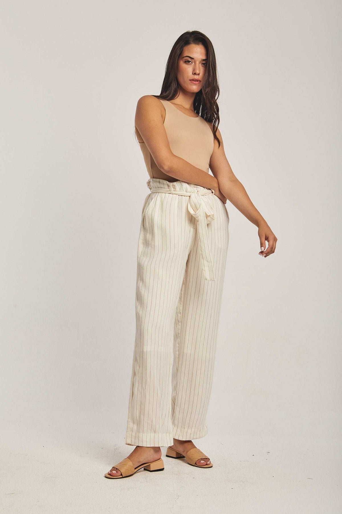 Dalydress women's fashion, model in beige sleeveless top and striped wide-leg pants