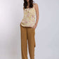 Woman modeling Dalydress floral ruffle top with mustard wide-leg pants, casual chic look
