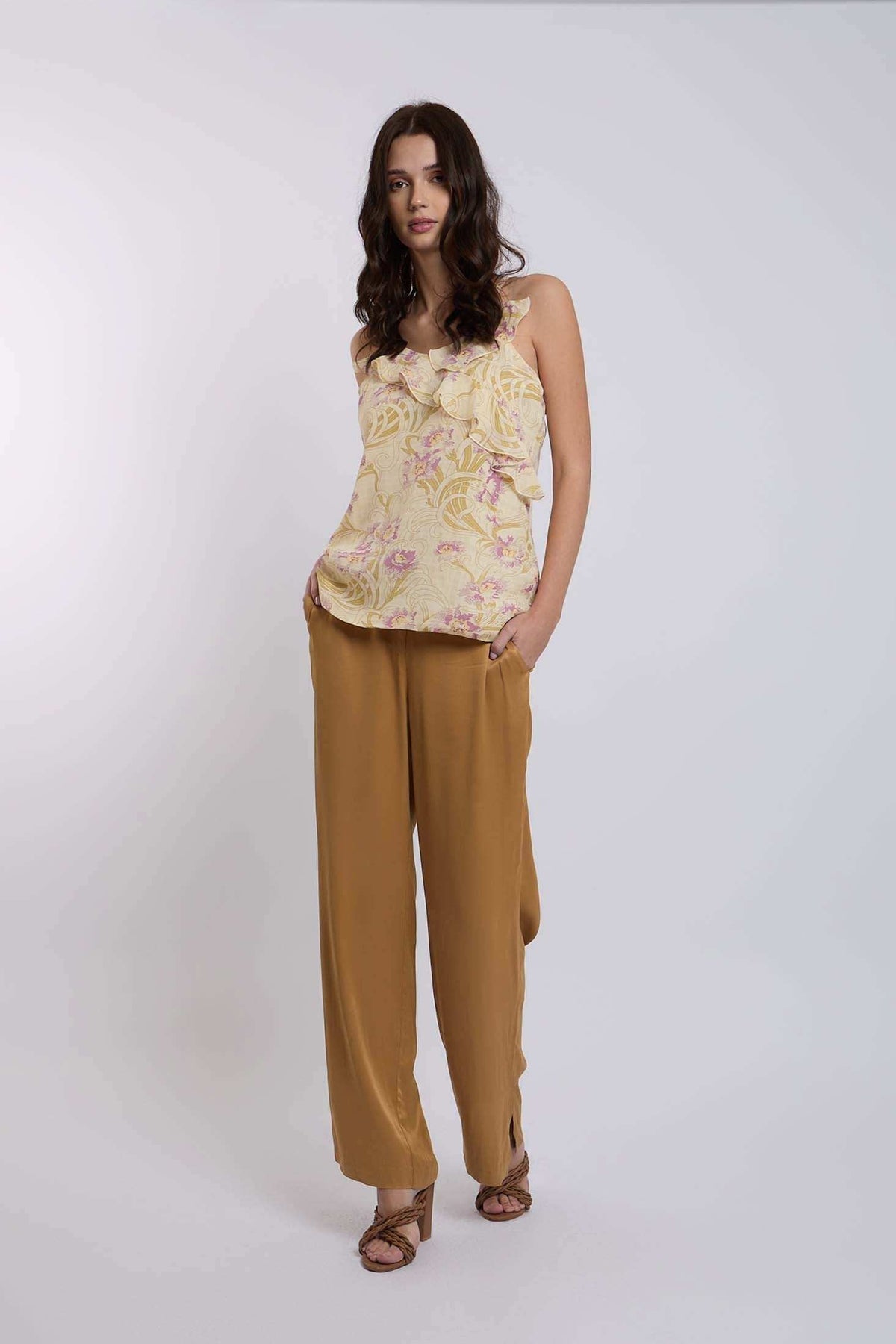 Woman modeling Dalydress floral ruffle top with mustard wide-leg pants, casual chic look