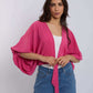 Woman in Dalydress pink kimono top and blue studded jeans, casual women's fashion