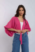 Woman in Dalydress pink kimono top and blue studded jeans, casual women&