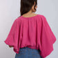 Woman in loose pink blouse and blue jeans, Dalydress casual women's fashion style