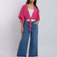 Woman in pink tie-front blouse and wide-leg studded jeans by Dalydress, casual fashion