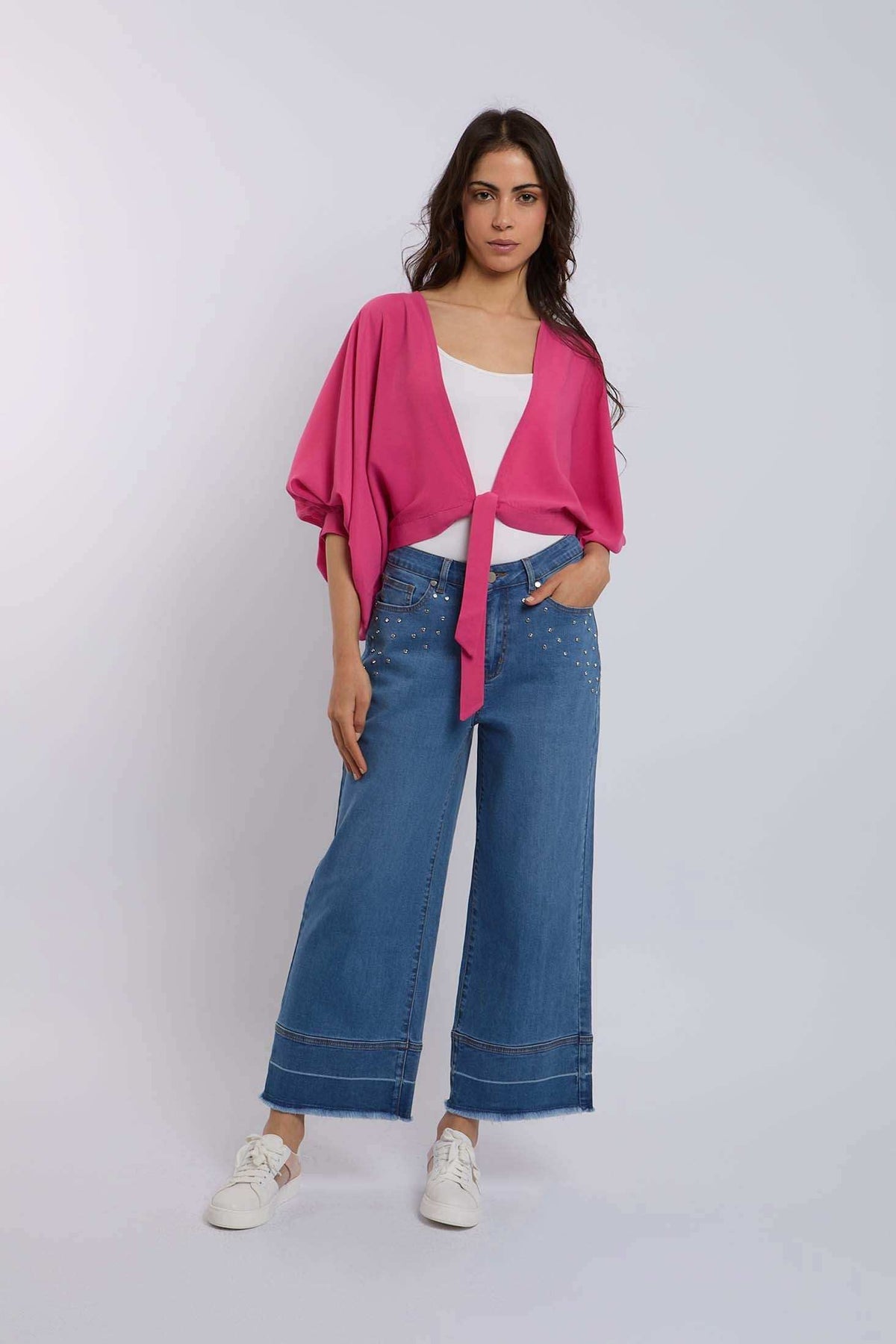 Woman in pink tie-front blouse and wide-leg studded jeans by Dalydress, casual fashion
