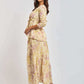 Woman in Dalydress yellow floral print set with flowy maxi skirt and three-quarter sleeve top