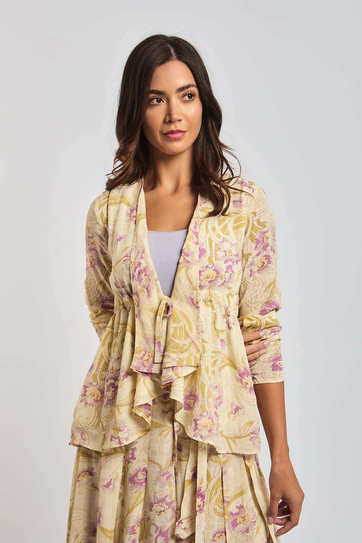 Woman wearing Dalydress cream floral print dress with ruffle detail, fashion studio shot