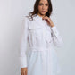 Woman wearing Dalydress white belted shirt with pockets and green pants, casual modern style