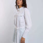 Woman wearing Dalydress white belted shirt and green pants, modern minimalist fashion