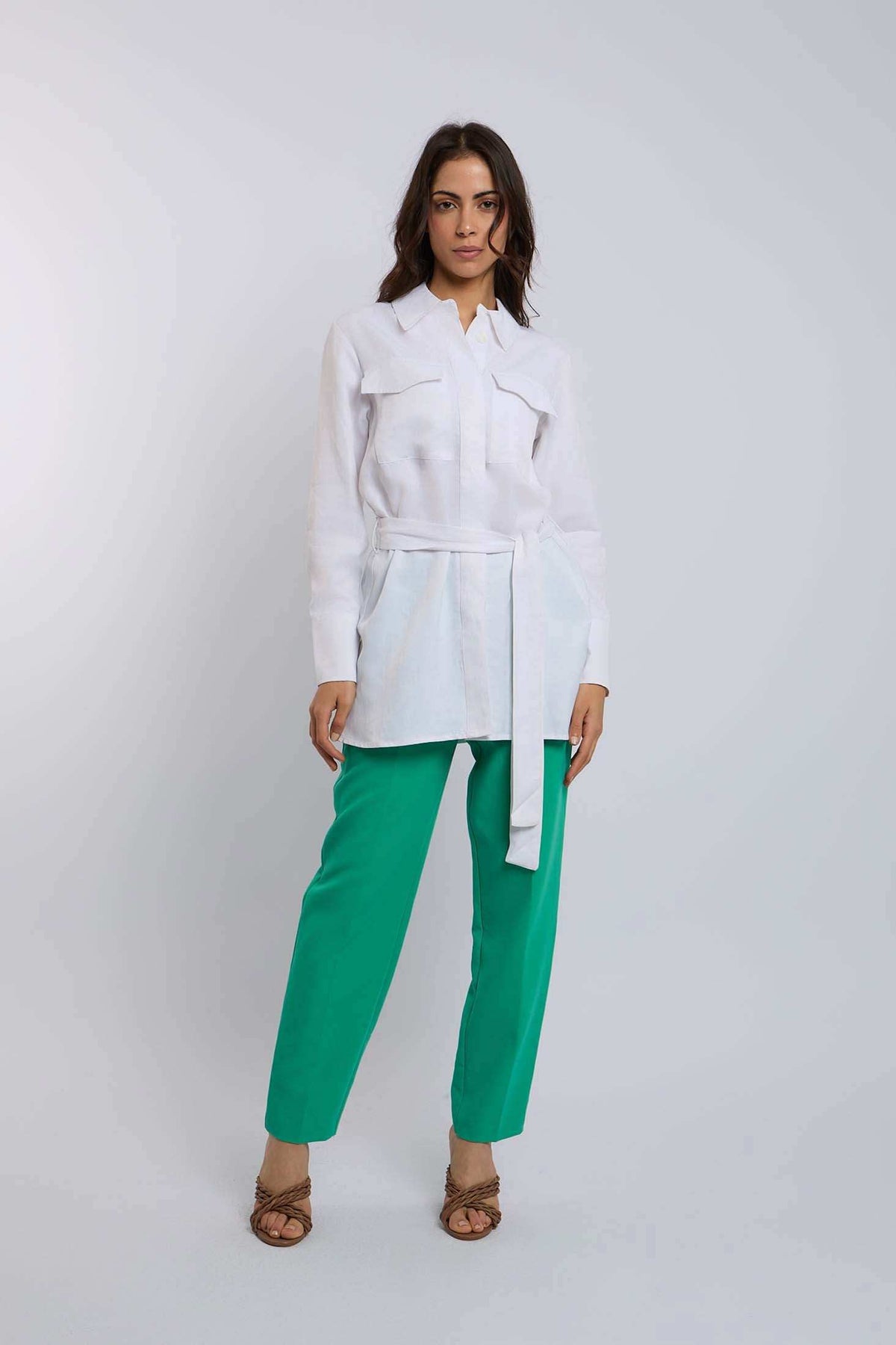 Woman wearing Dalydress white belted shirt and green pants, casual fashion look