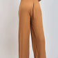Back view of woman wearing loose-fit camel brown high-waisted wide-leg pants