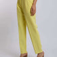 Woman wearing high-waisted yellow tailored pants and brown block heel sandals