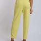 Woman wearing high-waisted yellow pants and brown heels, back view, casual fashion
