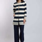 Woman wearing Dalydress navy and cream striped jacket with embroidered trim and navy pants.