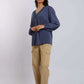 Woman wearing a blue long-sleeve blouse with v-neck and beige cargo pants