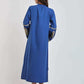 Woman wearing a long blue dress with gold embroidery details, back view