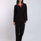 Woman wearing black tailored suit with wide-leg pants and a pink collared blouse