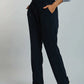 Women's casual navy jogger pants with elastic waistband and drawstring, styled with white sneakers and a light blue button-up shirt.