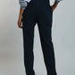 Woman wearing relaxed black pants and a light blue blouse, back view, casual fashion