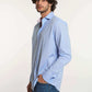 Man wearing a Dalydress light blue button-down shirt and jeans, casual men’s fashion