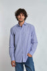 Man wearing Dalydress blue striped long sleeve shirt and jeans on white background