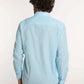 Man wearing light blue long sleeve Dalydress shirt and khaki pants, shown from the back