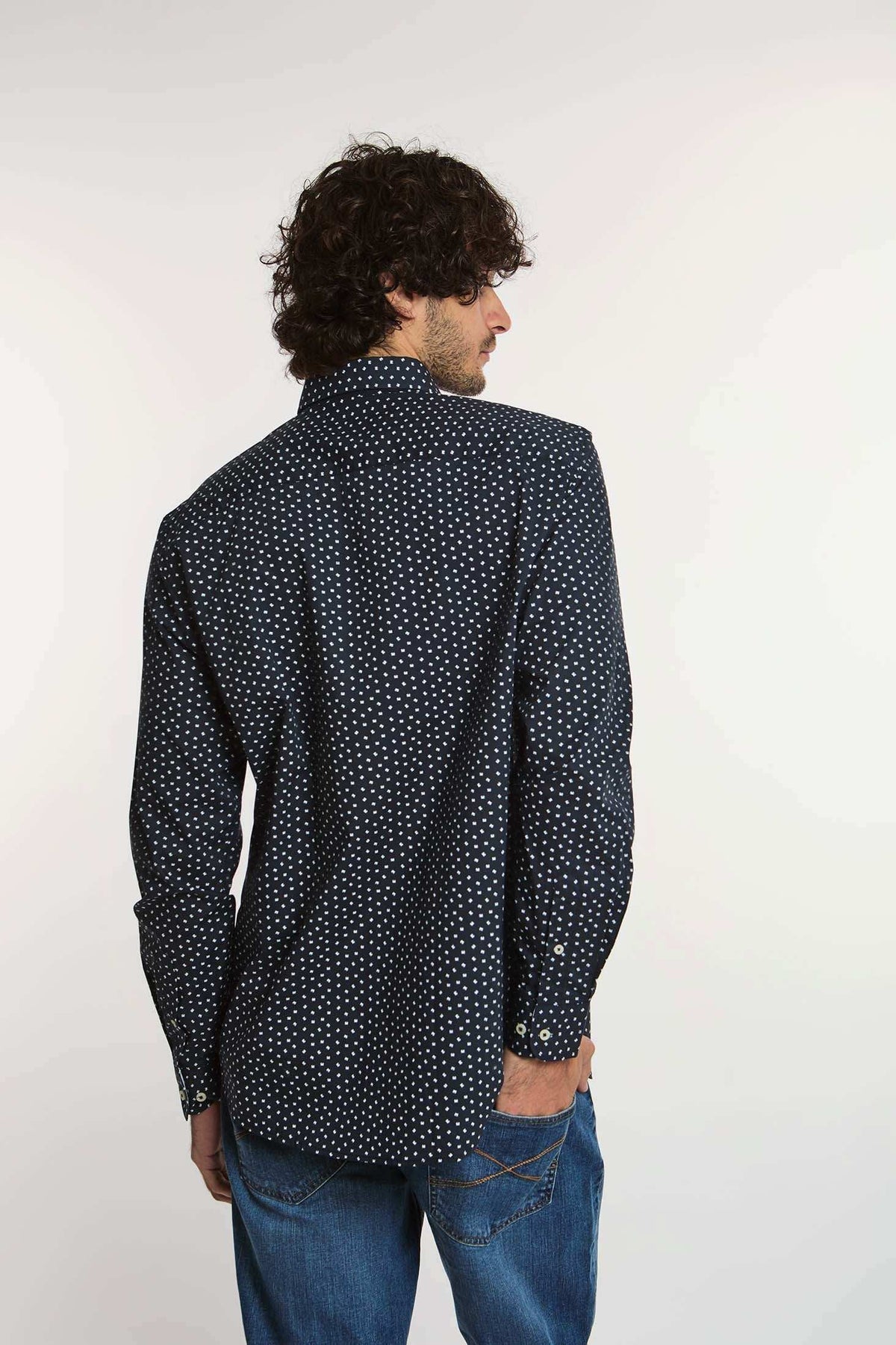 Dalydress men’s navy blue polka dot shirt with long sleeves and blue jeans, back view
