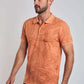 Man wearing orange floral print polo shirt with short sleeves and black pants