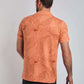 Back view of man in orange floral short sleeve polo shirt and dark jeans