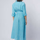 Woman wearing a light blue belted midi dress with rolled sleeves, shown from the back