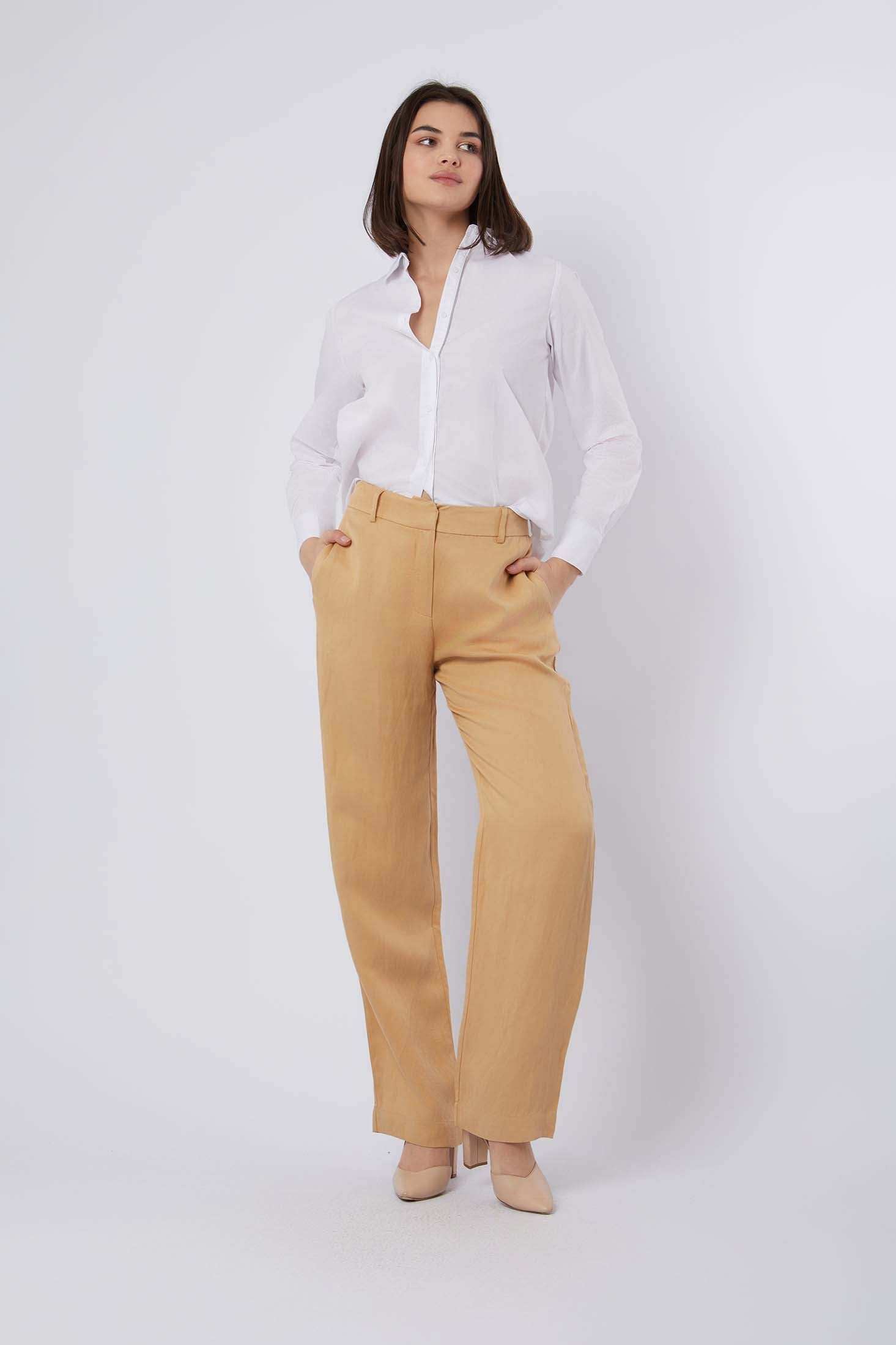 Woman in white button-up shirt and tan wide-leg pants with beige heels, casual chic outfit