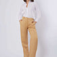 Woman in white button-up shirt and tan wide-leg pants with beige heels, casual chic outfit