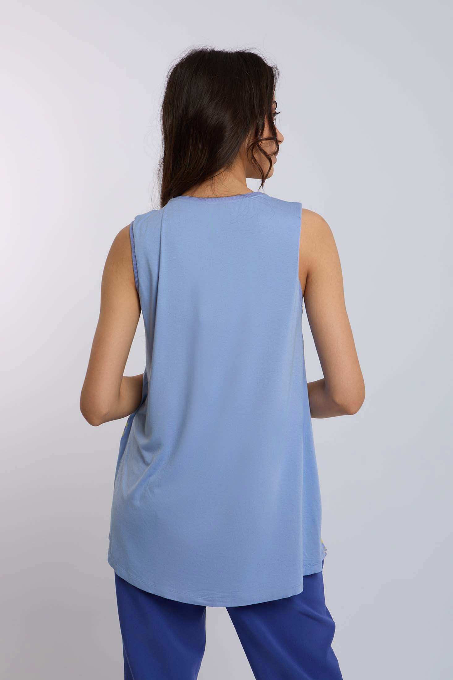 Woman wearing a sleeveless light blue top and blue pants, shown from the back.