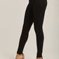 Women's high-waisted black skinny pants styled with beige heels on a neutral background