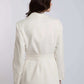 Woman wearing white belted blazer with long sleeves, back view, formal attire